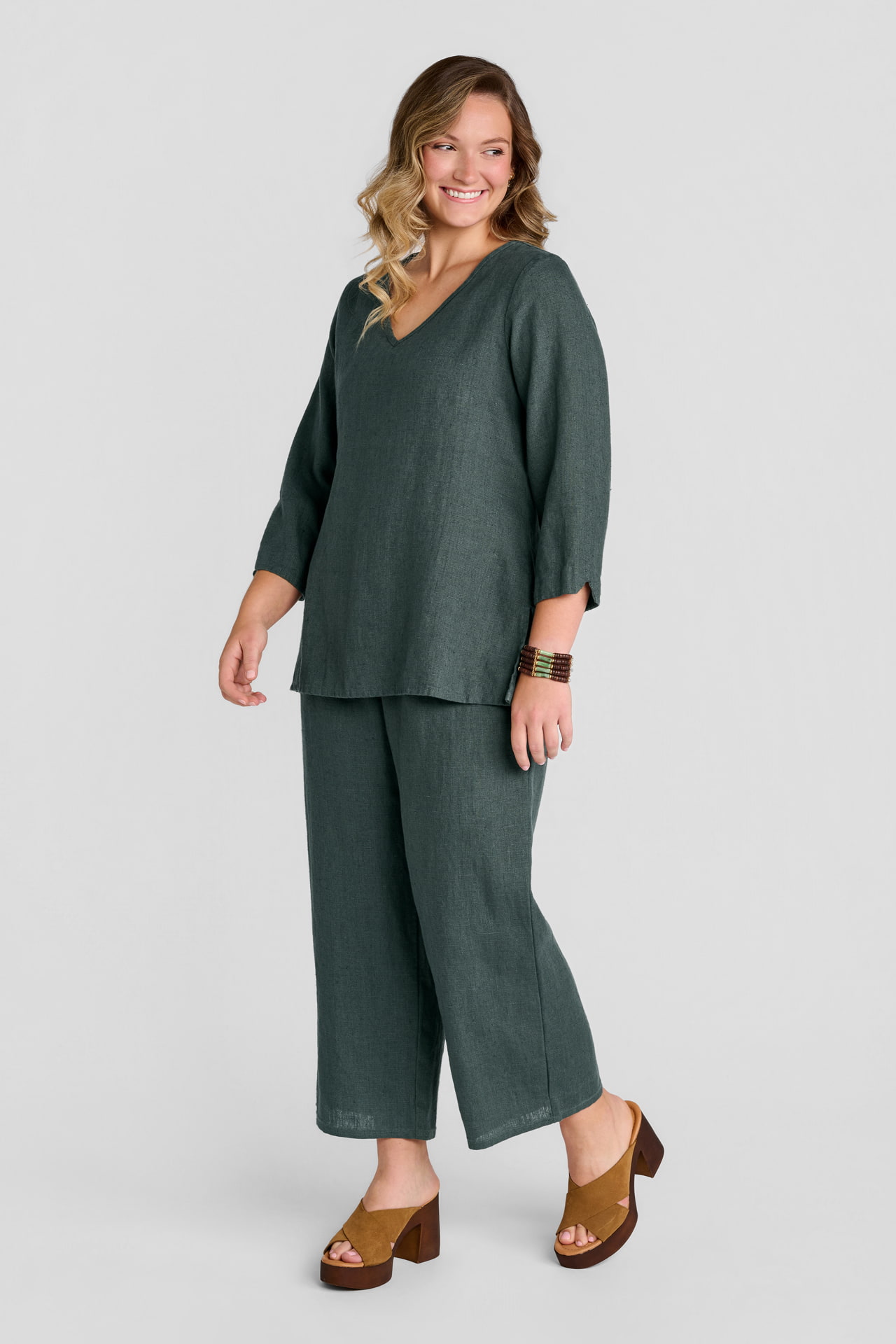 Woman in green linen pullover with green linen pants
